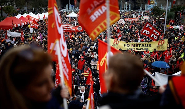 French protesters demonstrate against the government's pension reforms in Saint-Nazaire as part of the nationwide strikes (Reuters)