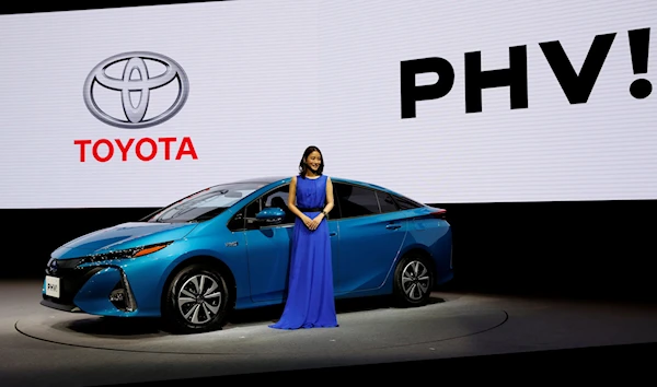 Japanese actress Satomi Ishihara poses beside Toyota's Prius Plug-in-Hybrid vehicle in Japan in 2017 (Reuters)