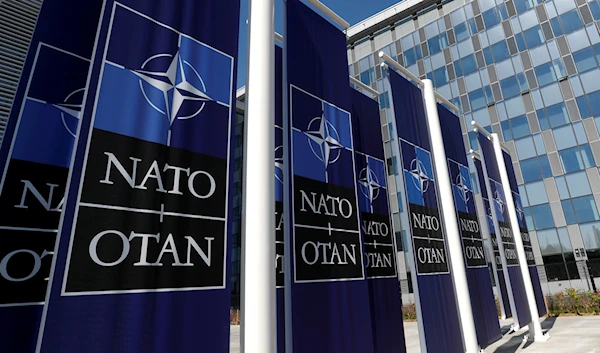 Banners displaying the NATO logo are placed at the entrance of new NATO headquarters (Reuters).