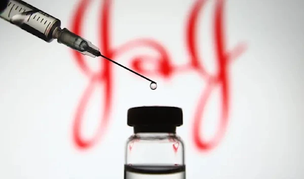 In this photo illustration a Johnson & Johnson logo is seen in front of a medical syringe. (Getty images)