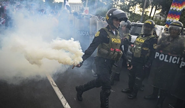 SMOKE GETS IN YOUR EYES A riot police officer throws smoke during a protest against the government of Peruvian President Dina Boluarte in Lima on Tuesday, Jan. 17, 2023. AFP PHOTO