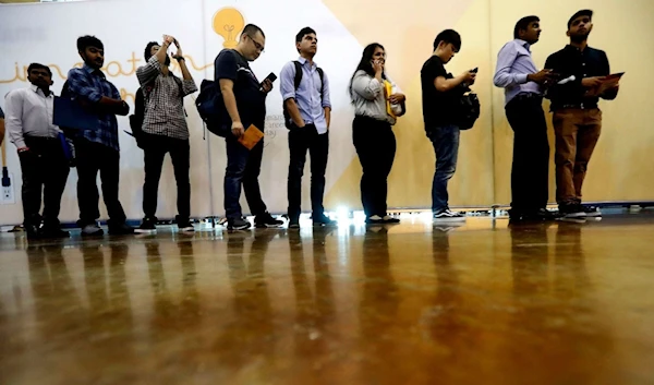 In this Sept. 17, 2019, photo job seekers line up to speak to recruiters during an Amazon job fair in Dallas. Lm Otero/AP, FILE