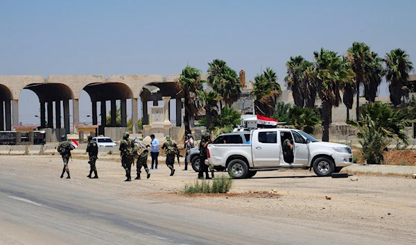 In this photo released by the Syrian official news agency SANA, shows Syrian troops patrolling the Naseeb border crossing with Jordan, in the southern province of Daraa, Syria, Saturday, July 7, 2018 (SANA via AP)