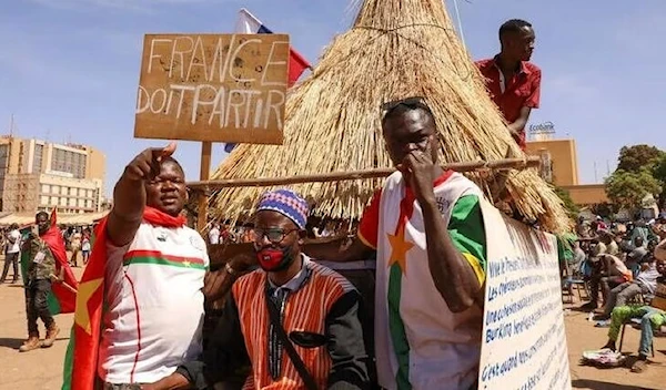 People hold a sign to show their support to the Junta leader Ibrahim Traore and demand the departure of the French ambassador at the Place de la Nation in Ouagadougou, Burkina Faso, January 20, 2023 (Reuters).