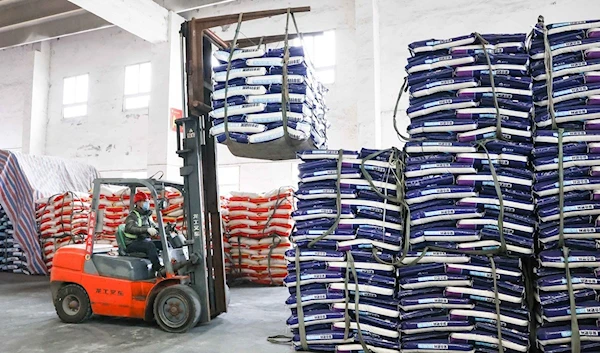 Workers load fertilizer at an industrial park in Ruichang, East China's Jiangxi Province on February 15, 2022. As the spring ploughing season approaches, workers have been speeding up fertilizer production to meet rising demand.