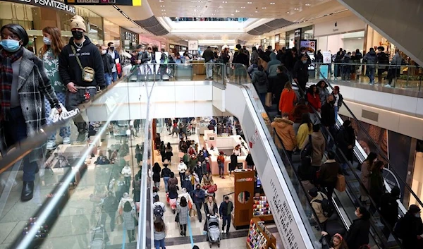 People walk through the Westfield Stratford City shopping centre in London, Britain, December 5, 2020 (Reuters)