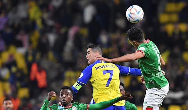 Al Nassr's Cristiano Ronaldo, centre, jumps for the ball against Al Ettifaq's players during the Saudi Pro League match between Al Nassr and Al Ettifaq at Mrsool Park Stadium, in Riyadh, Saudi Arabia, Sunday, Jan. 22, 2023 (AP Photo)