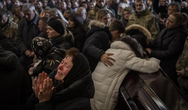 Relatives and friends attend a funeral ceremony for four of the Ukrainian military servicemen, who were killed during an airstrike in a military base in Yavoriv, in a church in Lviv, Ukraine, March 15, 2022. (AP)