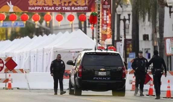 Police officers stand outside a ballroom dance club in Monterey Park, Calif., on Jan. 22, 2023. (AP Photo)