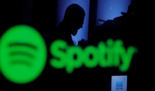 A trader is reflected in a computer screen displaying the Spotify brand at the New York Stock Exchange in New York, US. (REUTERS)