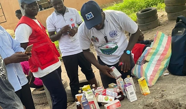 Volunteers examining contaminated cough syrups during recall exercises in The Gambia with the WHO (Twitter/WHOGambia)