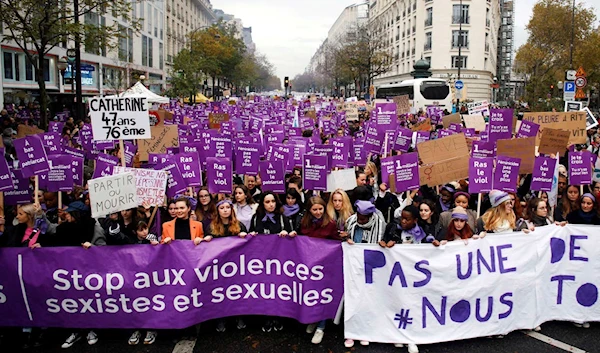 Women carry a banner that says "stop sexist and sexual violence" in November 2021 in Paris (AP)