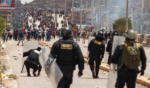 Supporters of ousted President Pedro Castillo clash with police forces in the Peruvian city of Juliaca, on January 7, 2023. Dozens of journalists have been attacked and harassed amid protests following Castillo's impeachment. (AFP)