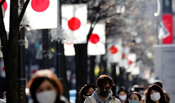 Pedestrians wearing protective masks, amid the coronavirus outbreak, make their way at Ginza shopping district Tokyo, Japan, January 10, 2021(REUTERS)