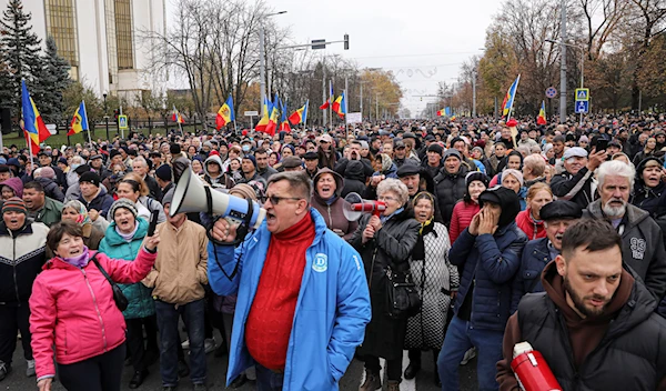 People chant slogans during a protest initiated by the populist Shor Party, calling for early elections and President Maia Sandu's resignation, in Chisinau, Moldova, Sunday, Nov. 13, 2022 (AP Photo/Aurel Obreja, File)