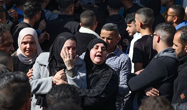 Family members of one of the Palestinian people killed during the Israeli raid on January 26, 2023 mourn during his funeral procession in Jenin. (AFP)