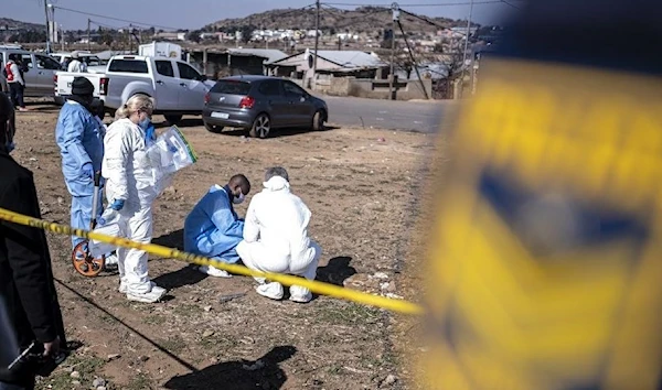 South African Police Service (SAPS) officers enforce a perimeter around a crime scene in Soweto on July 10, 2022. (AFP)