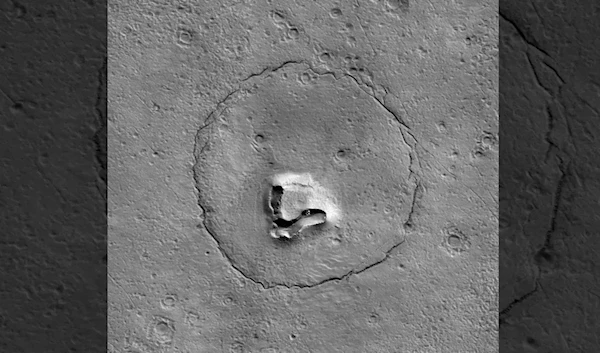 This cracked hillside on Mars looks like the face of a teddy bear as seen by NASA's Mars Reconnaissance Orbiter above the Red Planet. (NASA)