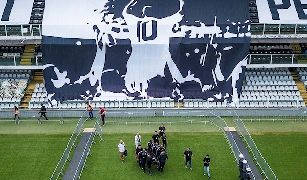 The coffin with the remains of Brazilian soccer great Pele is carried for his wake on the pitch of the Vila Belmiro stadium in Santos, Brazil, Monday, Jan. 2, 2023.(AP /Matias Delacroix)