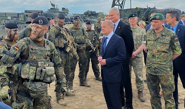 German Chancellor Olaf Scholz and Lithuanian President Gitanas Nauseda visit German troops of the NATO enhanced Forward Presence Battlegroup in Pabrade, Lithuania June 7, 2022 (Reuters)