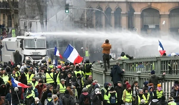 A police vehicle sprays water cannon at protesters during an anti-government demonstration in Paris on January 26, 2019. (Getty Images)