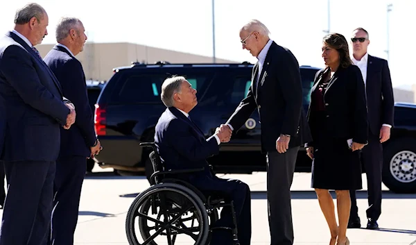 President Joe Biden shakes hands with Texas Governor Greg Abbott upon his arrival in El Paso on Jan. 8, 2023 (Reuters)