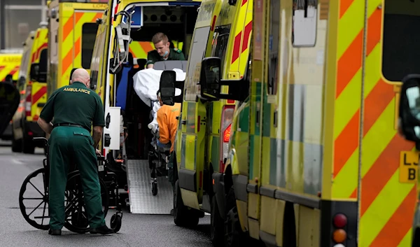 A patient is taken in to an ambulance as other ambulances wait outside the Royal London Hospital in east London, Wednesday, Jan. 4, 2023 (AP Photo/Alastair Grant, File)