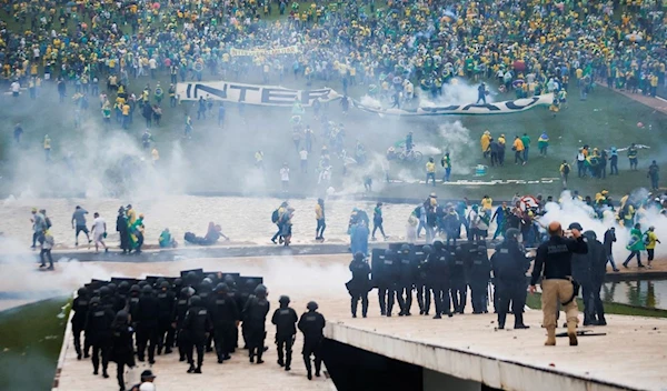 Supporters of Brazil's former President Jair Bolsonaro demonstrate against President Luiz Inacio Lula da Silva while security forces operate, outside Brazil’s National Congress in Brasilia, Brazil, January 8, 2023 (Reuters).