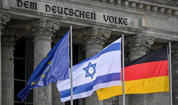 European, Israeli and German flags, from left, are pictured outside the German parliament Bundestag in Berlin, Germany, Wednesday, Oct.11, 2023. (AP Photo/Stefanie Loos)