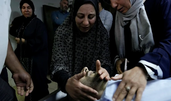 Palestinians mourn their relative Moaz Odeh, 28, reportedly killed in an attack by Israeli settlers at Qusra village, a hospital in the West Bank city of Nablus, Wednesday, Oct. 11, 2023. (AP Photo/Majdi Mohammed)