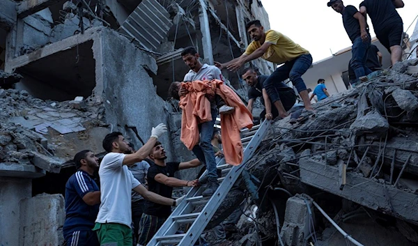 Palestinians rescue a young girl from the rubble of a destroyed residential building following an Israeli airstrike, Tuesday, Oct. 10, 2023 (AP)