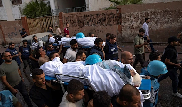 Palestinians, including some journalists, carry the bodies of two Palestinian reporters, Mohammed Soboh and Said al-Tawil, who were killed by an Israeli airstrike in the besieged Gaza City, Occupied Palestine, Tuesday, Oct. 10, 2023. (AP)