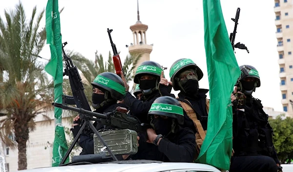 Masked militants from Al-Qassam Brigades, the military wing of Hamas, ride vehicles as they commemorate the 30th anniversary of their group, in Gaza City, Wednesday, Dec. 13, 2017 (AP)