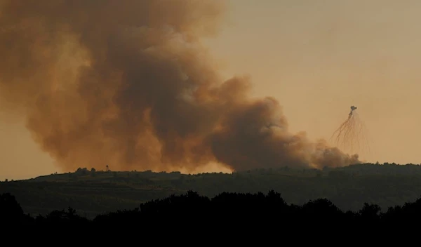 Smoke rise from Israeli shelling, at Alma al-Shaab border village with Israel, south Lebanon, Friday, Oct. 13, 2023 (AP Photo/Hassan Ammar)