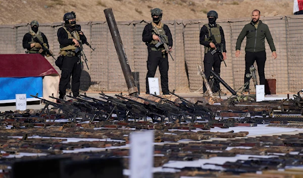 The Popular Mobilization Forces (PMF) display weapons seized from ISIS in Salahuddin province, north of Baghdad, Iraq, Jan 12, 2023 (AP)