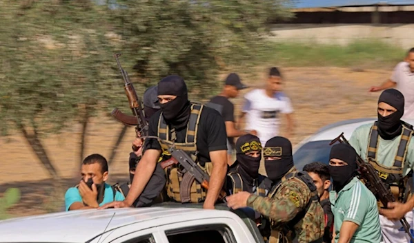 Palestinian fighters move towards the border fence with "Israel" from Khan Yunis in the southern Gaza Strip on October 7, 2023. (AFP)