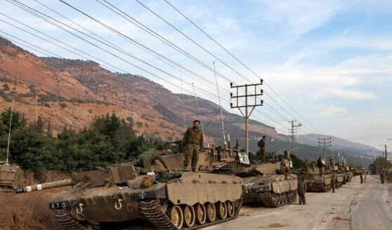 A column of Israeli Merkava battle tanks is amassed in upper al-Jalil near the border with Lebanon on October 11, 2023. (AFP)