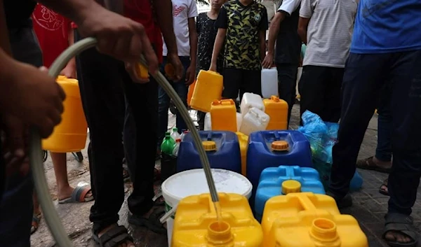 Palestinians queue to refill on water in Rafah refugee camp in the southern of Gaza Strip. (AFP)