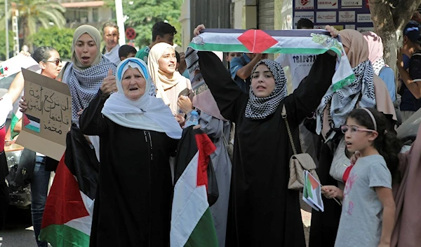 People take part in a protest in solidarity with Palestine, in downtown Algiers, Friday, Oct. 13, 2023 (AP Photo/Fateh Guidoum)