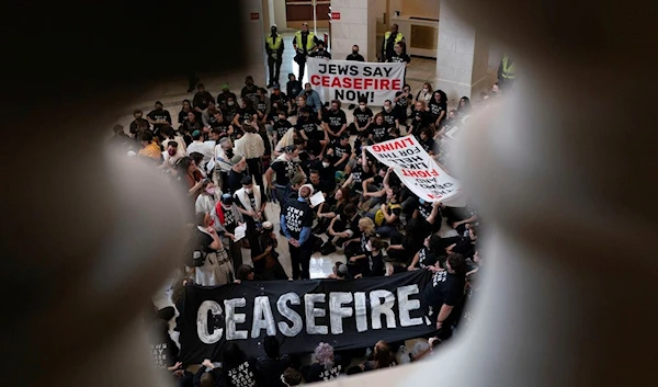 Demonstrators protest inside the Cannon House Office Building on Capitol Hill in Washington, Wednesday, Oct. 18, 2023 (AP Photo/Jose Luis Magana)