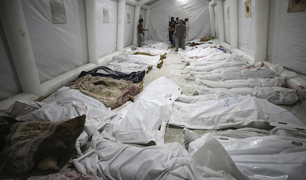 Bodies of Palestinians killed by an air strike at the Ahli Arab hospital are gathered at the front yard of the al-Shifa hospital, in Gaza City, central Gaza Strip on October 17, 2023. (AP)