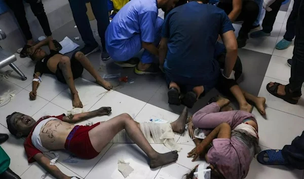 Palestinian medics tend to children wounded by Israeli air strikes at al-Shifa hospital in Gaza City on 11 October 2023. (AFP)