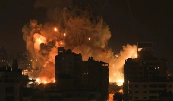 Fire and smoke rise above residential buildings in Gaza City during an Israeli airstrike on October 8, 2023. (AFP)