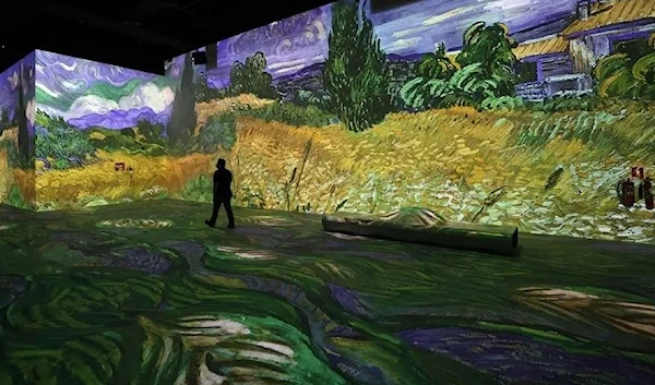 Visitors look at projected paintings and drawings at the Van Gogh exhibit during a preview of the digital exhibition titled "Infinity des Lumieres" in Dubai, in the United Arab Emirates, on June 28 , 2021. (AFP)