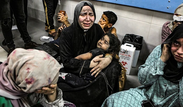 Wounded Palestinians sit in al-Shifa hospital in Gaza City, central Gaza Strip, after arriving from al-Ahli hospital following an explosion there, Tuesday, Oct. 17, 2023. (AP)