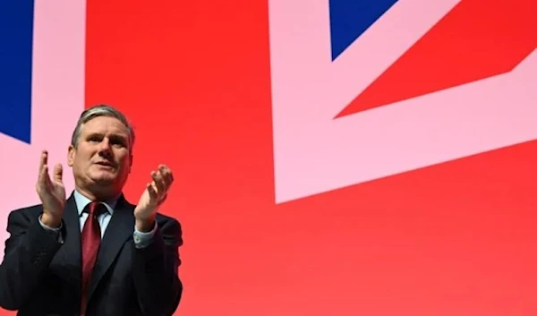 Britain’s main opposition Labour Party leader Keir Starmer applauds a speaker the final day of the annual Labour Party conference in Liverpool, northwest England, on October 11, 2023. (AFP via Getty Images)