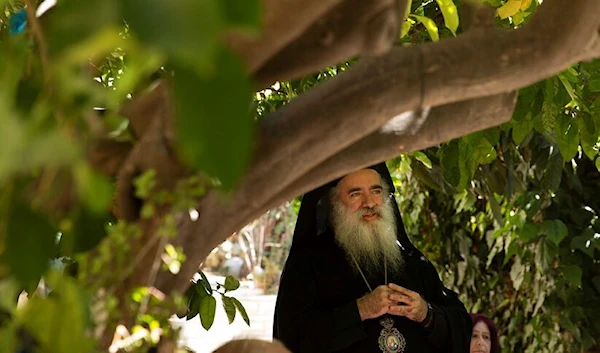 Greek Orthodox Archbishop Theodosios Atallah Hanna speaks to residents of the Sheikh Jarrah neighborhood, Al-Quds, Friday, May 15, 2021 (AP)