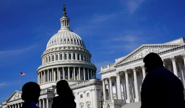 People walk outside the U.S Capitol building in Washington, June 9, 2022 (AP Photo/Patrick Semansky, File)