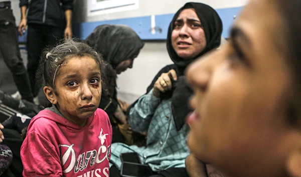 Wounded Palestinians seek care at al-Shifa Hospital after a deadly blast at another hospital. (AP)