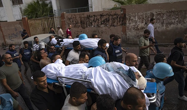 The bodies of Palestinian reporters Said Al-Tawil and Mohammed Soboh are carried on October 10, 2023 after being killed by Israeli bombing (AP)